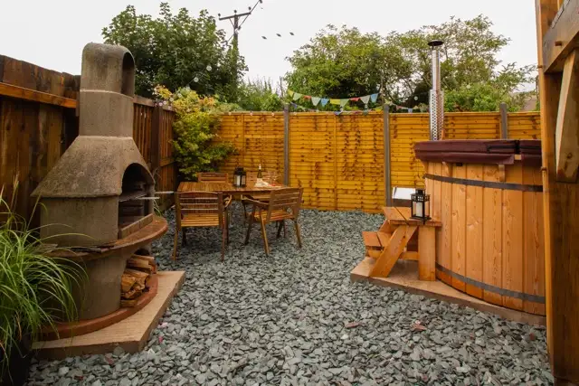 Charcoal BBQ on the private terrace at The Studio Cheddar — outdoor dining and al fresco entertaining at a boutique luxury self-catering lodge near Cheddar Gorge, Somerset